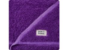 Folded purple towel with ‘Don’t Panic’ tag symbolising the mindset behind the PDSA cycle and effective continuous improvement
